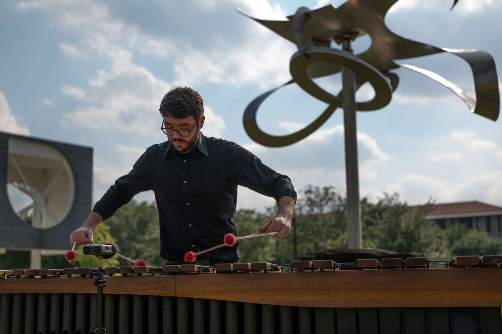 Shepherd School percussionist Aaron Smith performs a new composition by Shepherd School composer Theo Chandler inspired by Mark di Suvero's Po-um (Lyric) (2003). Photo by Daniel Ortiz.